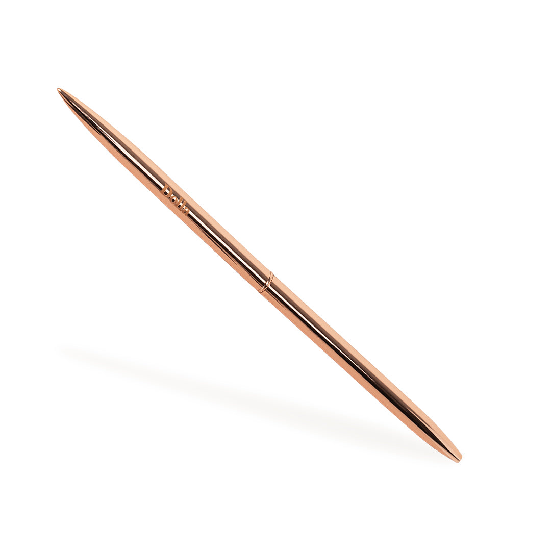 rose gold metallic ballpoint thin pen on white background