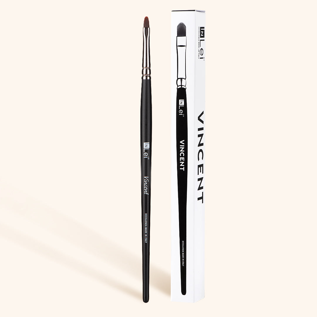 InLei Cat Tongue Eyebrow & Lash Brush next to its packaging, designed for precise application of brow and lash products.