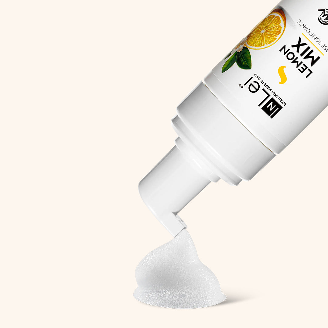 InLei Lemon Mousse Lash and Brow Cleanser being dispensed, showcasing its foamy texture in a clean and minimalistic setting.