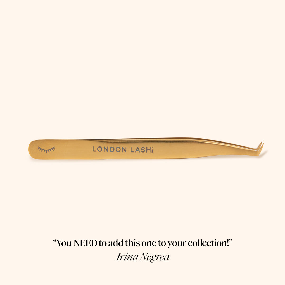 side picture of gold volume lash extension tweezers with engraved lashes and london lash logo