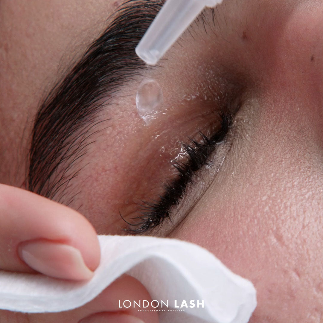 close-up of the washing client's natural lashes with water and cotton pad