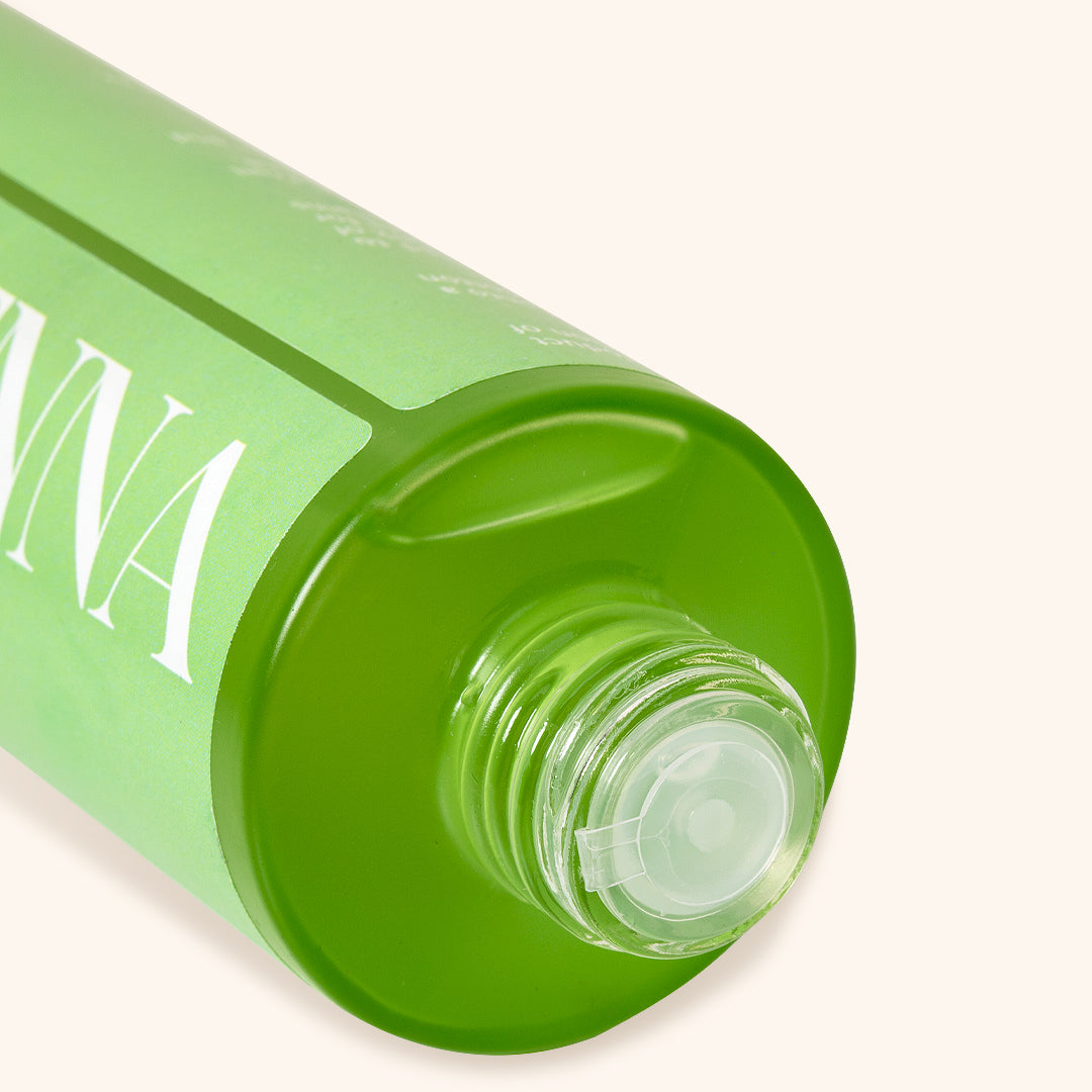 close up to the green bottle top with stain remover liquid inside
