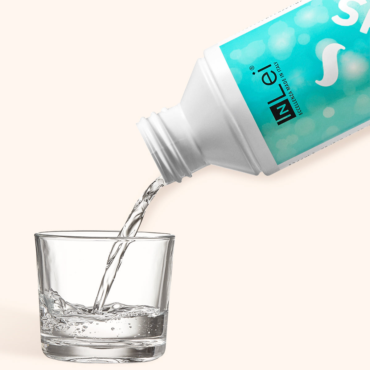 InLei F PLUS Sanitising Liquid being poured into a glass, highlighting its use for cleaning lash tools.
