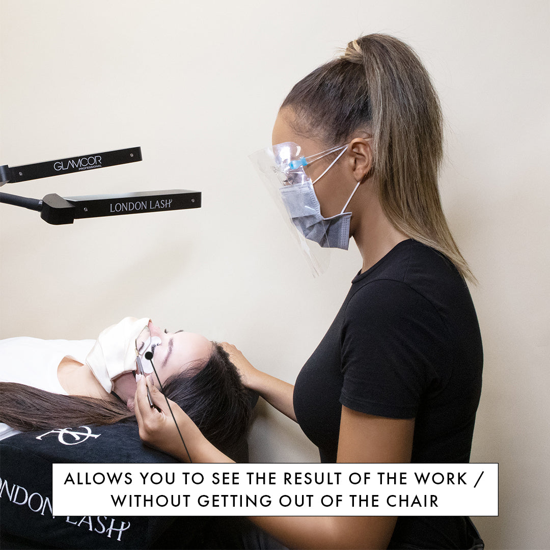  lash technician sitting at a beauty bed using the best eyelash extensions treatment mirror
